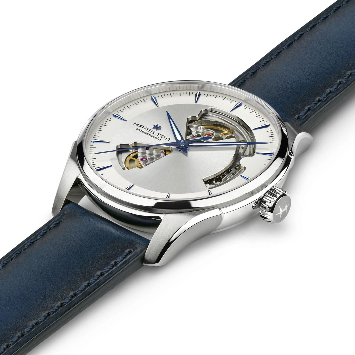 Open-heart automatic watch angled view with silver case, white dial, crown detail, blue leather strap