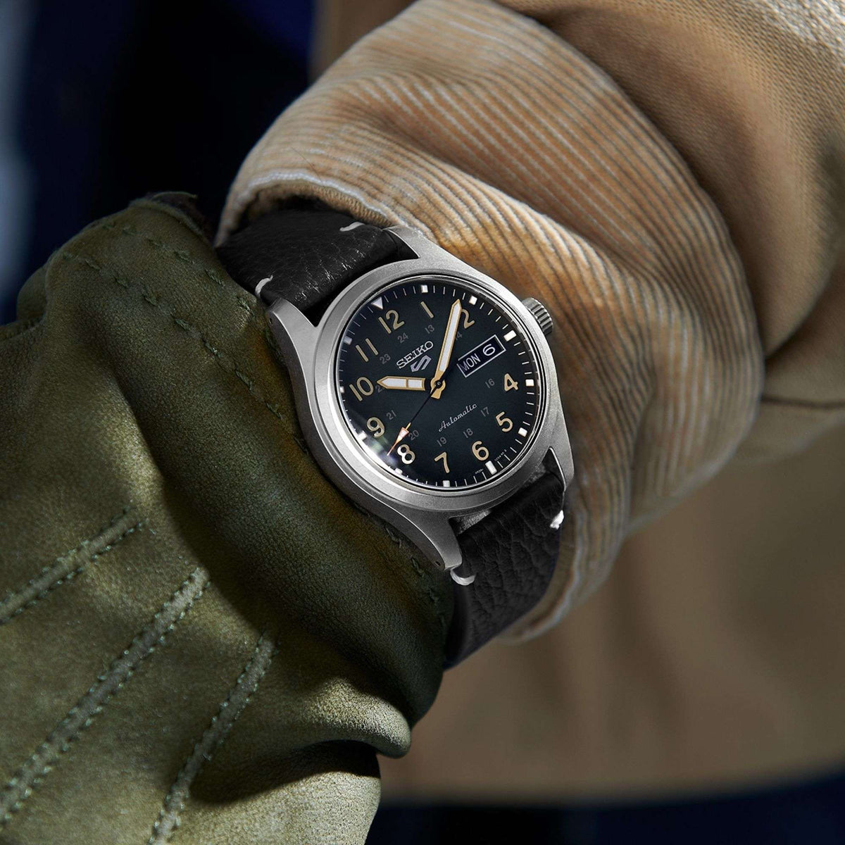 Men's automatic wristwatch with blue dial, date window, and black leather strap