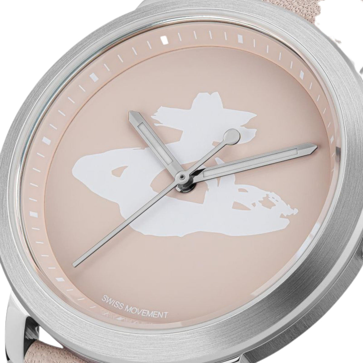 Ladies pink dial watch close-up with silver markers and white logo world hands