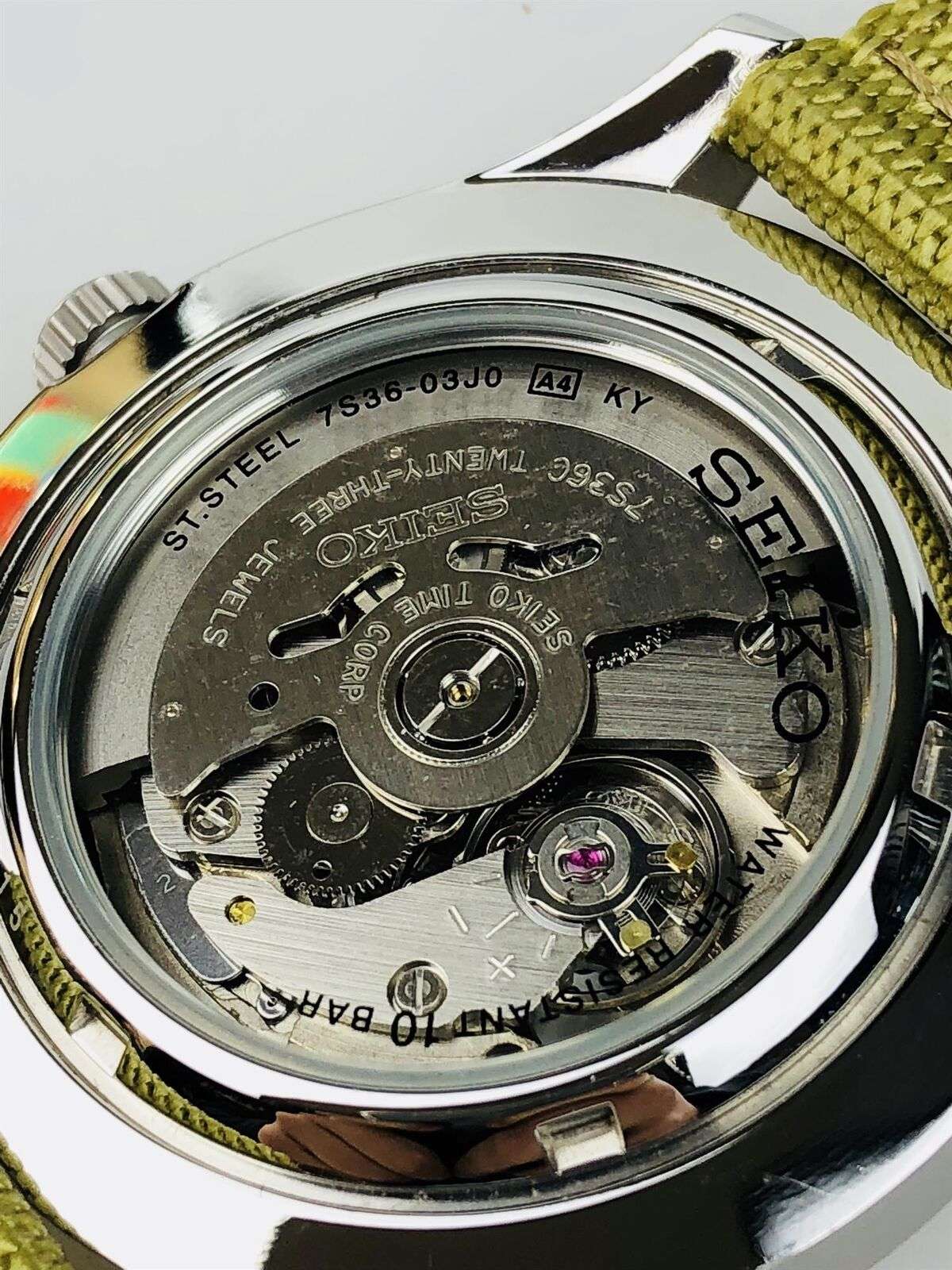 Seiko 5 Sports automatic watch caseback with visible mechanical movement under glass