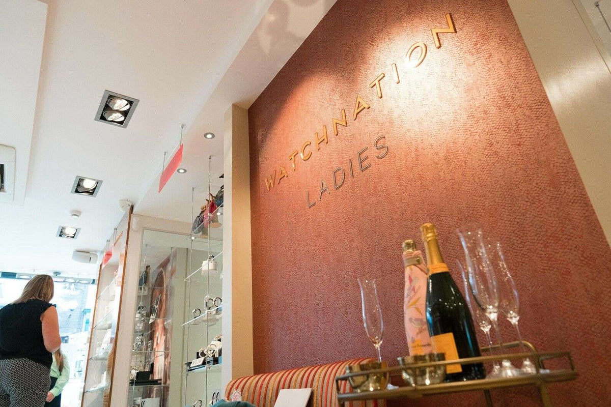 WatchNation Ladies sign on store wall with display bottles and glasses