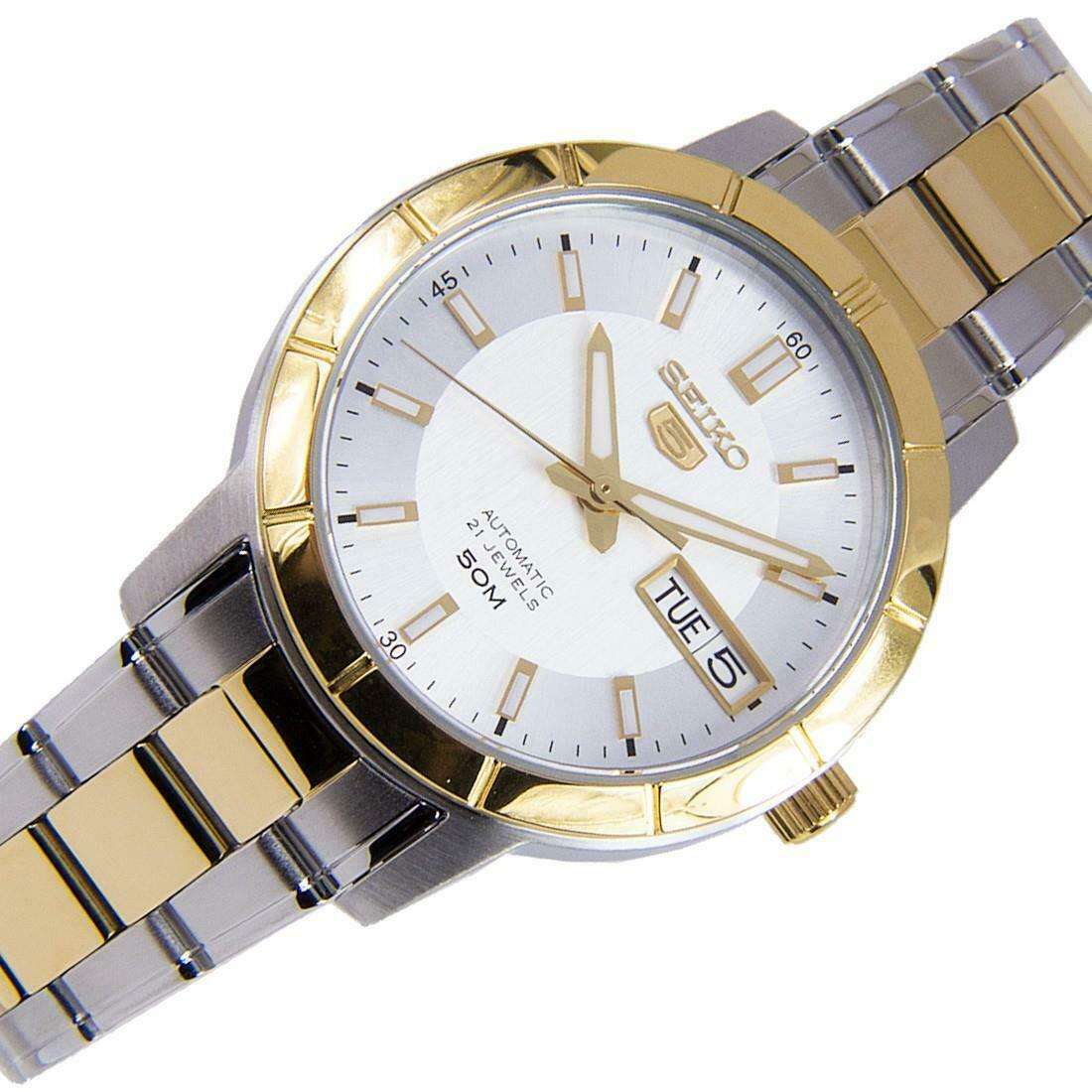 Angled view of two-tone stainless steel watch with white dial, gold markers, and day-date window