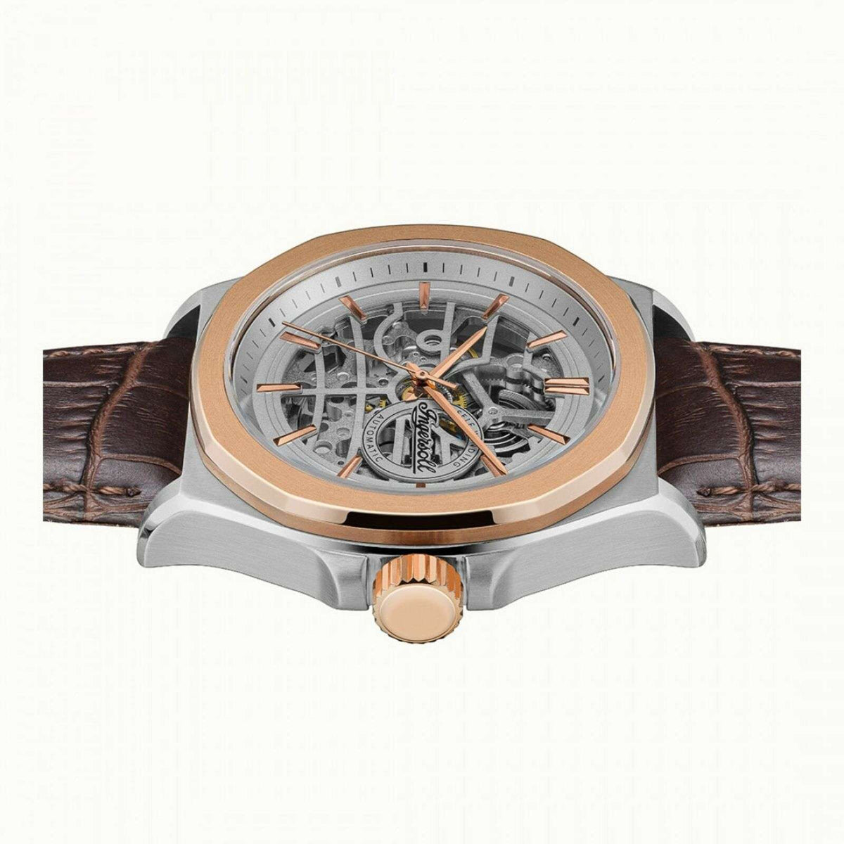 Men's automatic skeleton watch with silver-toned case, brown leather strap, orange hands.