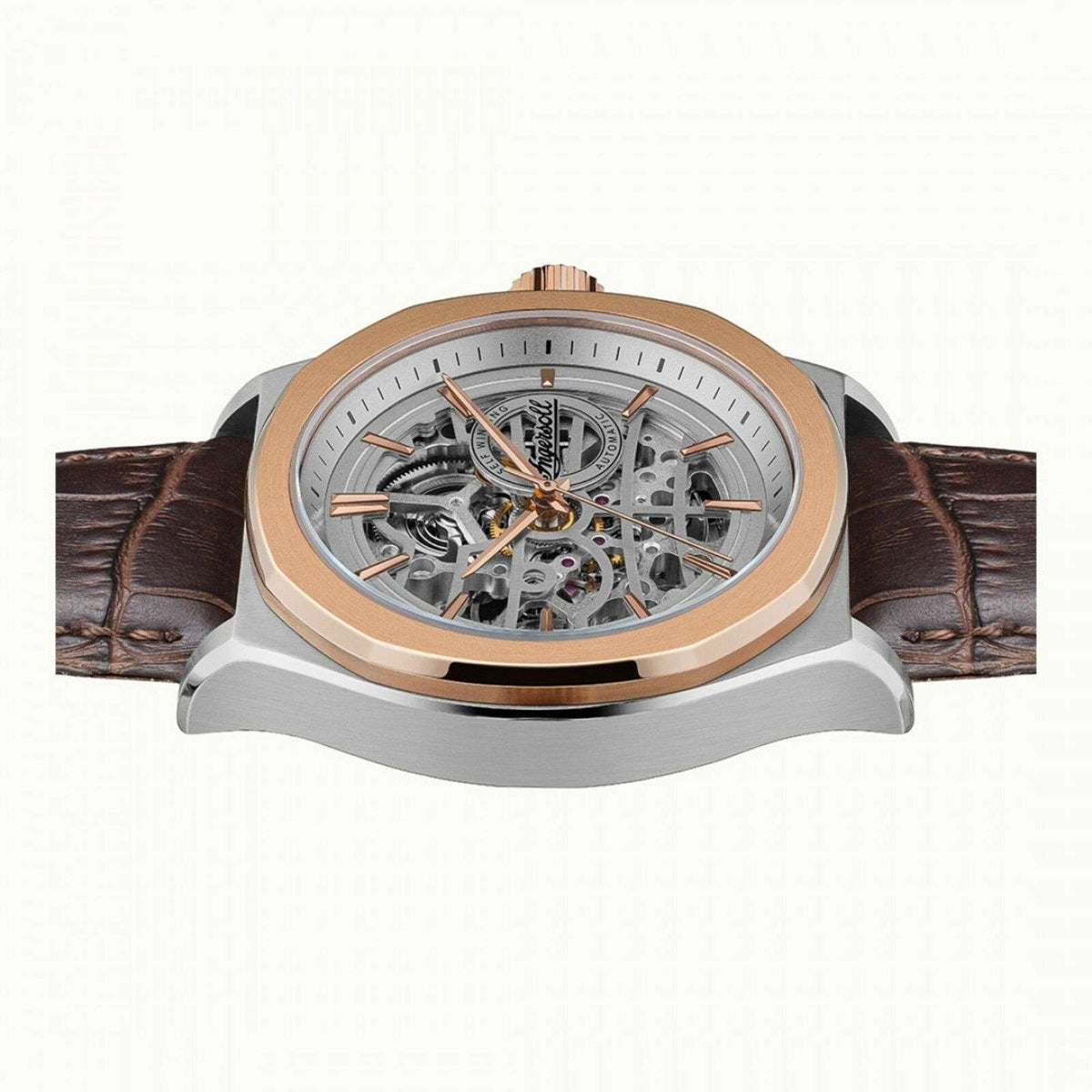 Men's automatic skeleton watch with silver-toned case, brown leather strap, open dial view.