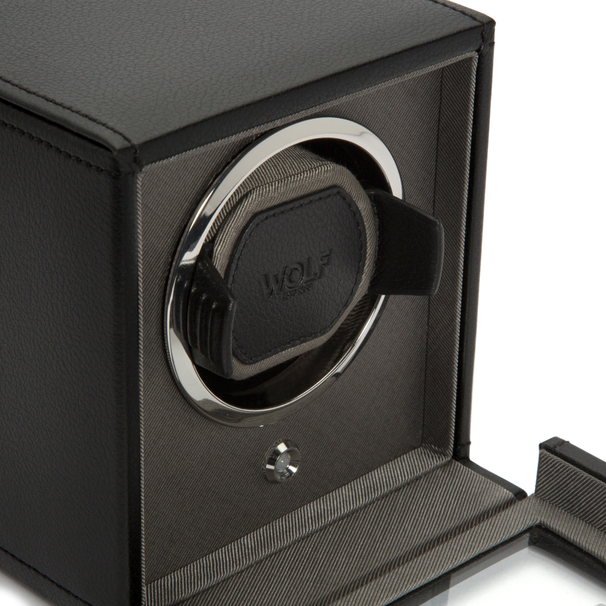 Black single watch winder close-up of circular WOLF winder and open lid