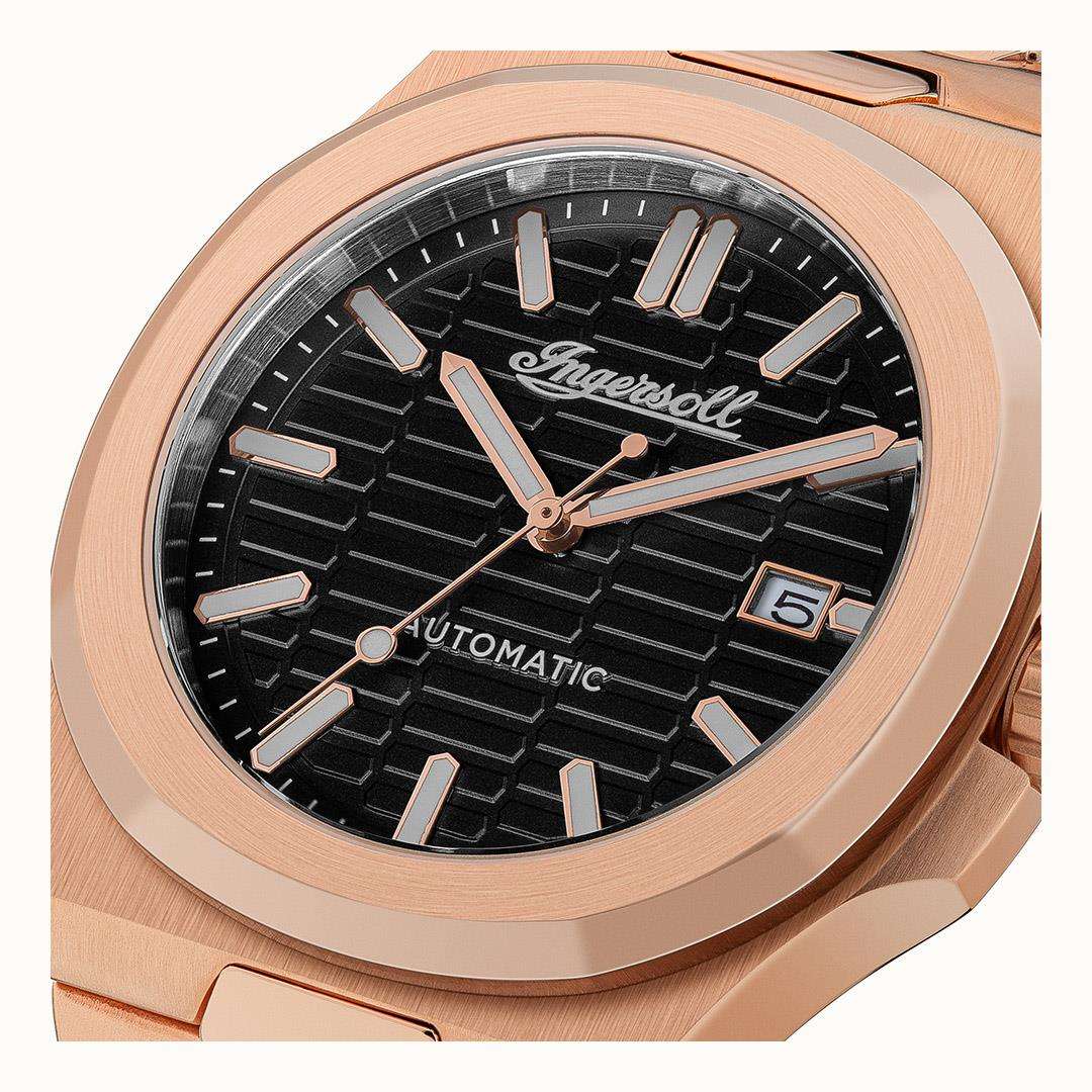 Ingersoll automatic watch close-up: black dial with baton markers, date window, rose-gold bezel