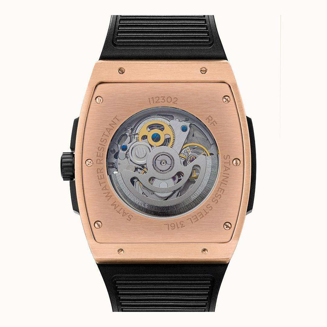Automatic watch caseback with exposed mechanism and black rubber strap.