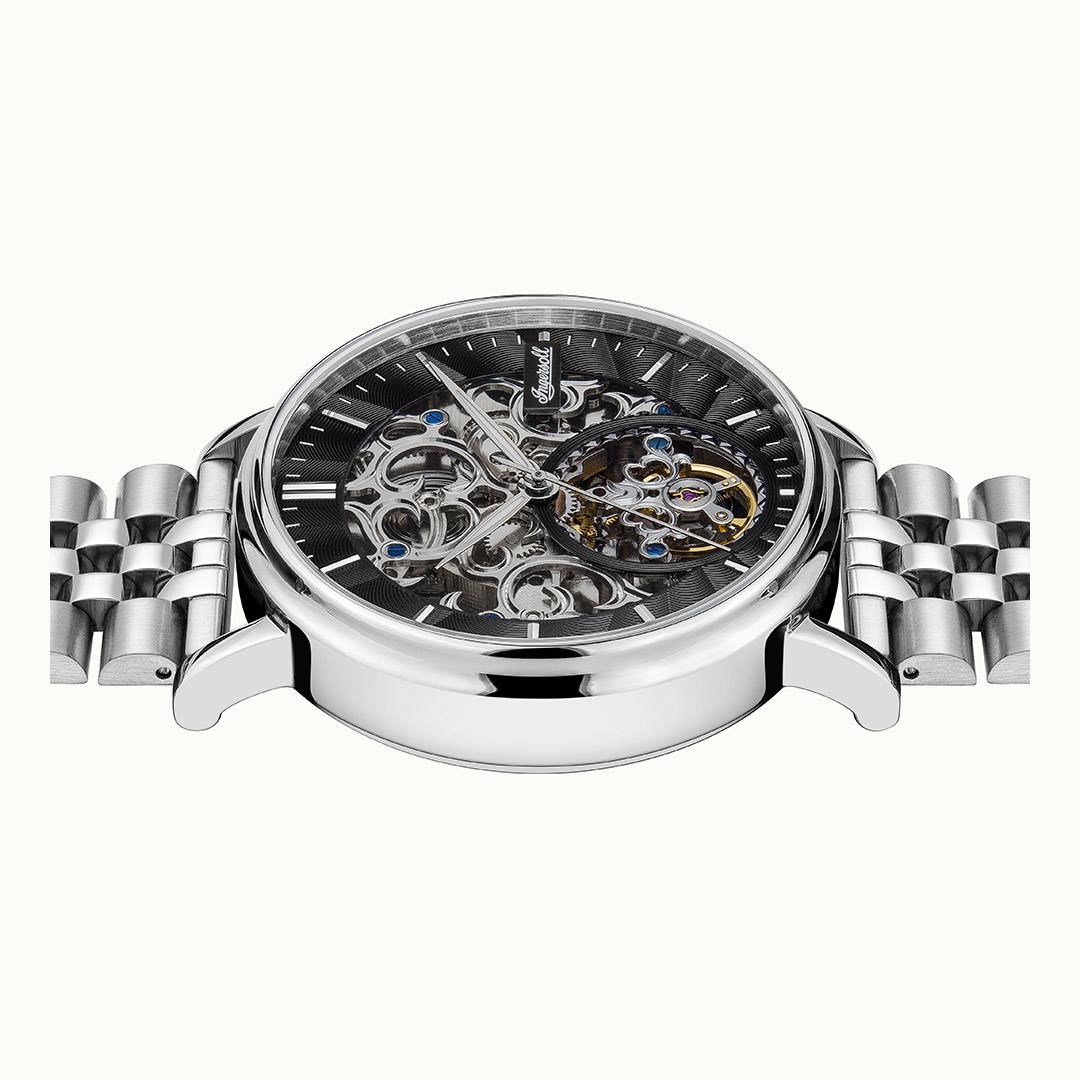 Automatic skeleton wristwatch with black dial, visible gears, and blue jeweled accents