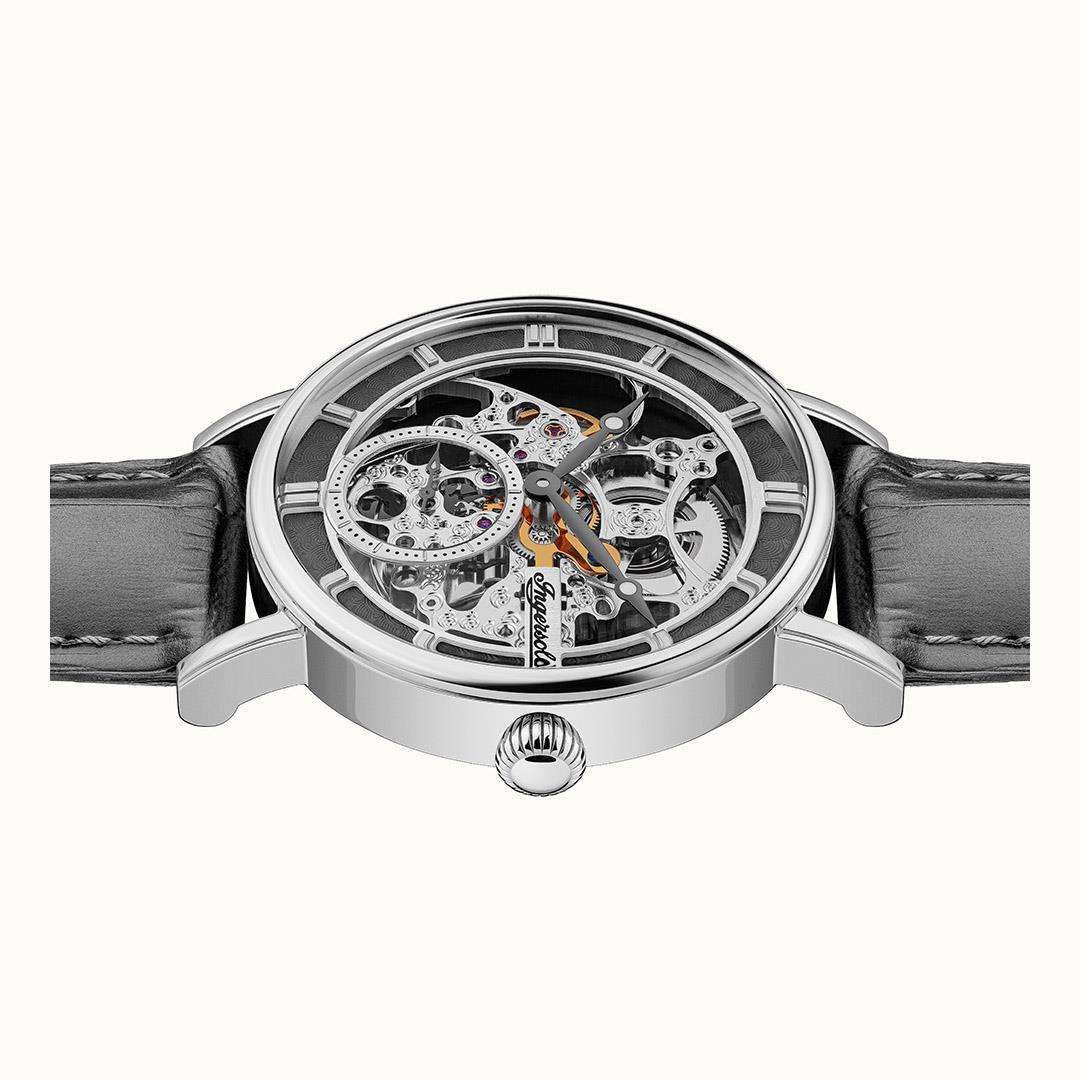 Watch case top view with grey leather strap, exposed movement under a clear bezel