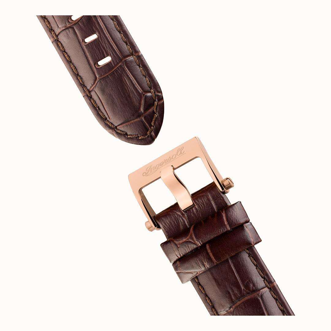 Brown leather watch strap with buckle and stitched edges; rose-gold clasp