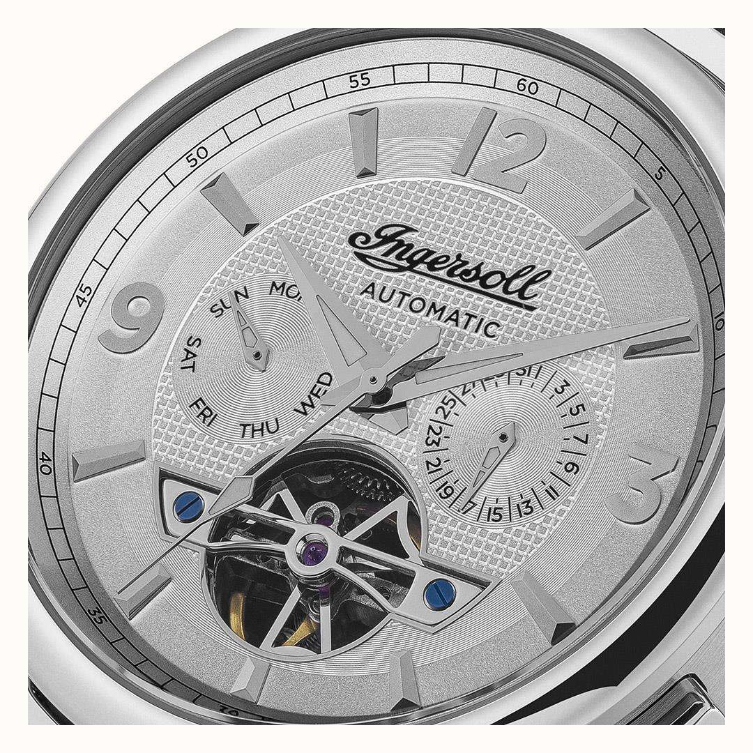 White dial automatic watch close-up with Roman numerals and visible hands