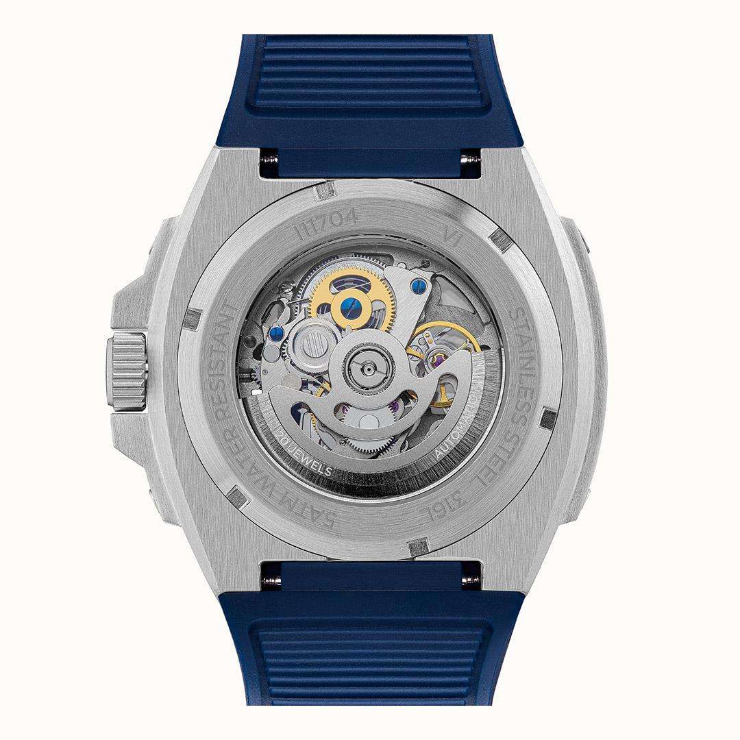 Men's automatic watch case with exposed movement and blue dial, on blue strap