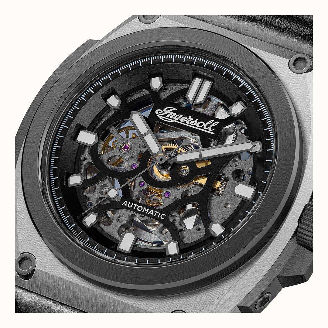Close-up of black dial automatic skeleton movement with exposed gears