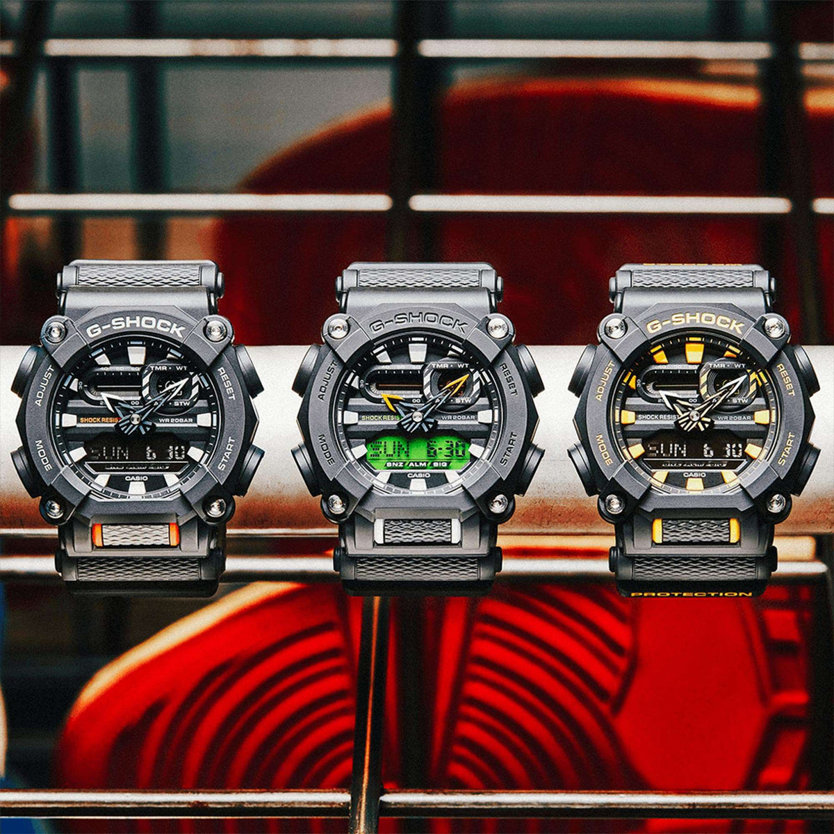 Three black sport watches with textured dials and silver metal bracelets, yellow accents