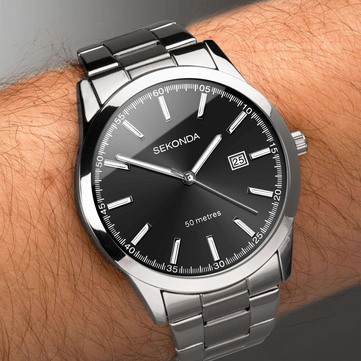 Men's stainless steel quartz watch on wrist, black dial with date window