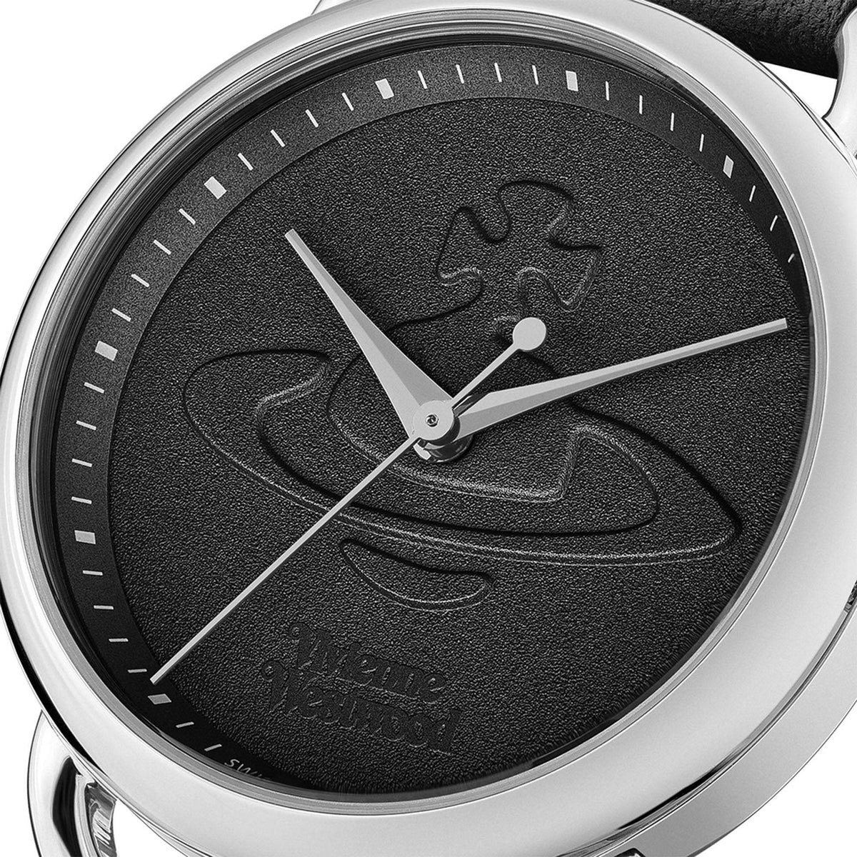 Quartz wristwatch dial close-up with black textured face, silver hands and markers