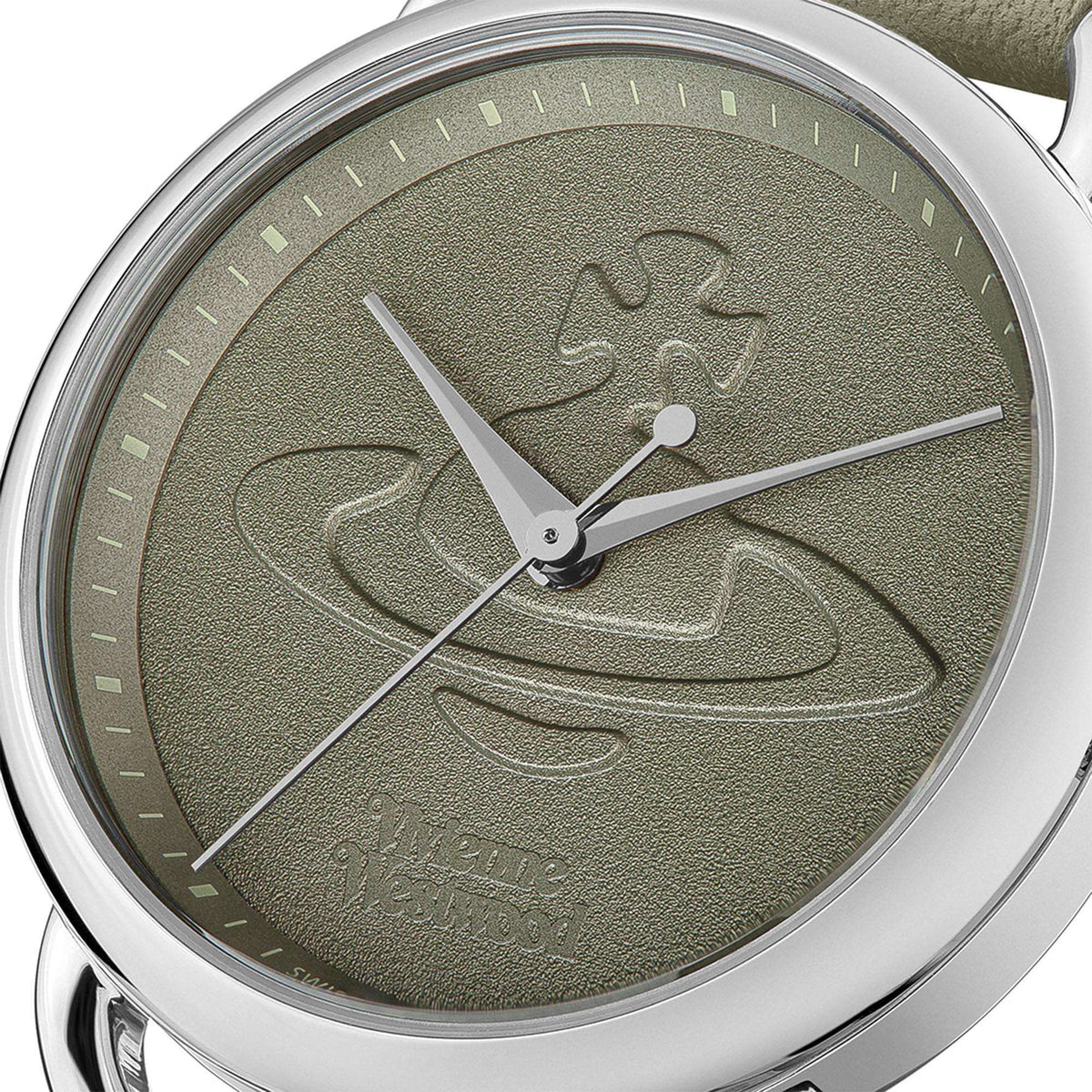 Close-up of olive green dial quartz watch with engraved symbol and silver hands