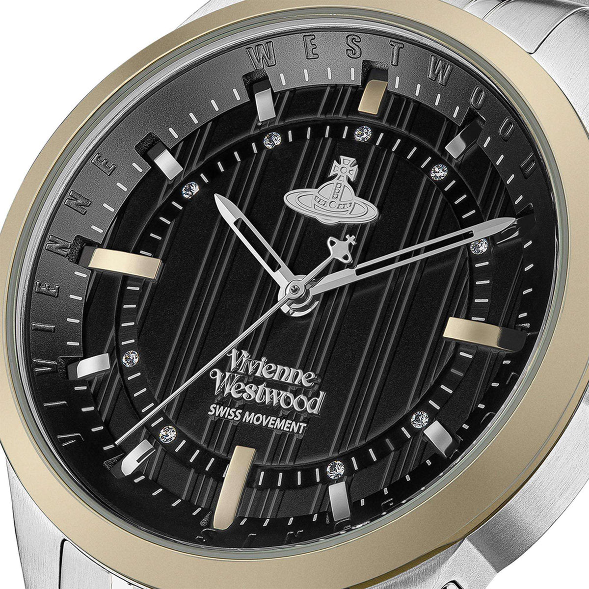 Close-up of quartz watch face: black dial with gold indices, silver hands, gold-toned bezel