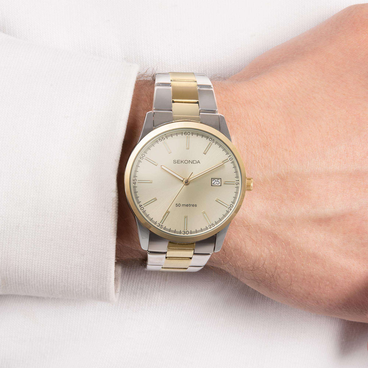 Two-tone men’s quartz watch on wrist with champagne dial and gold-accent hour markers