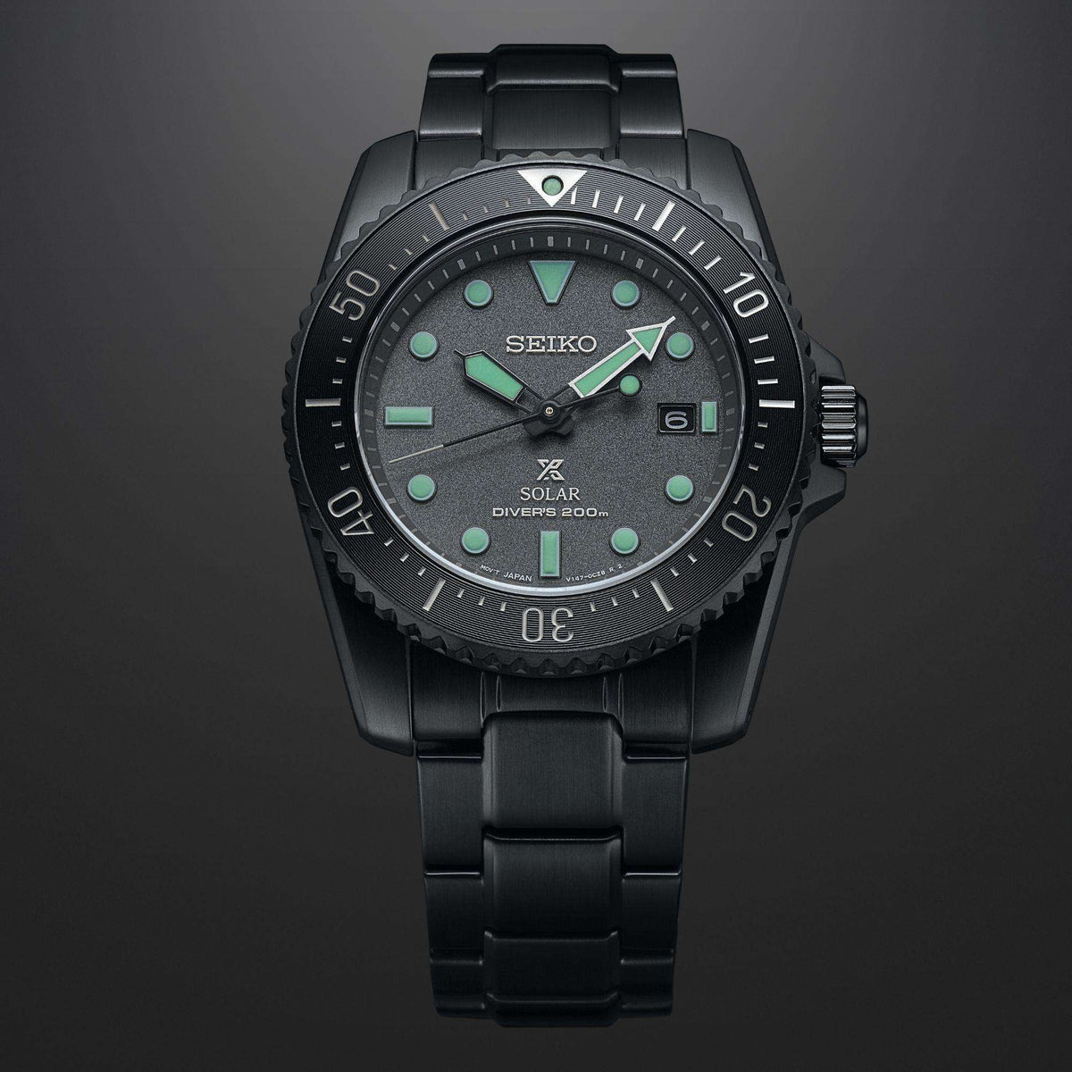 Seiko Prospex SNE587P1 green glowing hands and date display close up