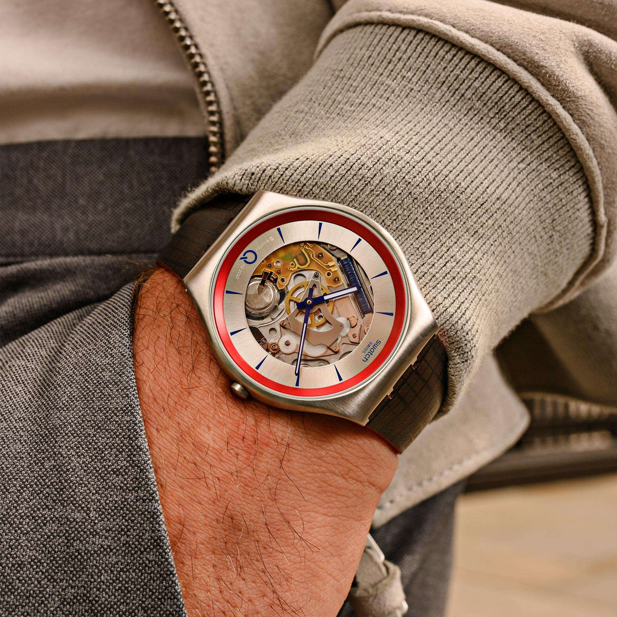 Mens skeleton dial quartz watch on wrist with stainless steel case and dark leather strap