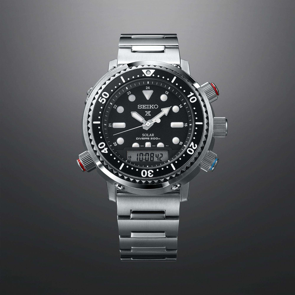 Stainless steel divers watch with black dial and colored bezel knobs on a metal bracelet