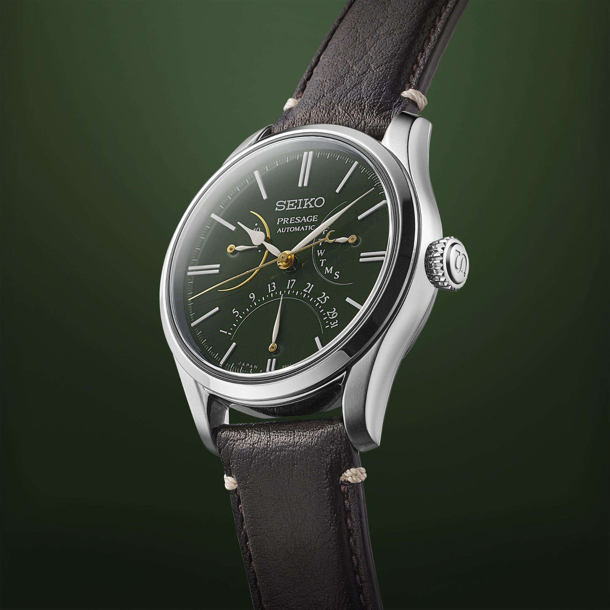 Men's automatic watch angled view with green dial, silver case, and black leather strap