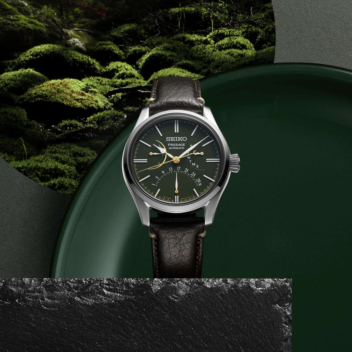 Men's automatic watch with green dial and black leather strap, silver bezel