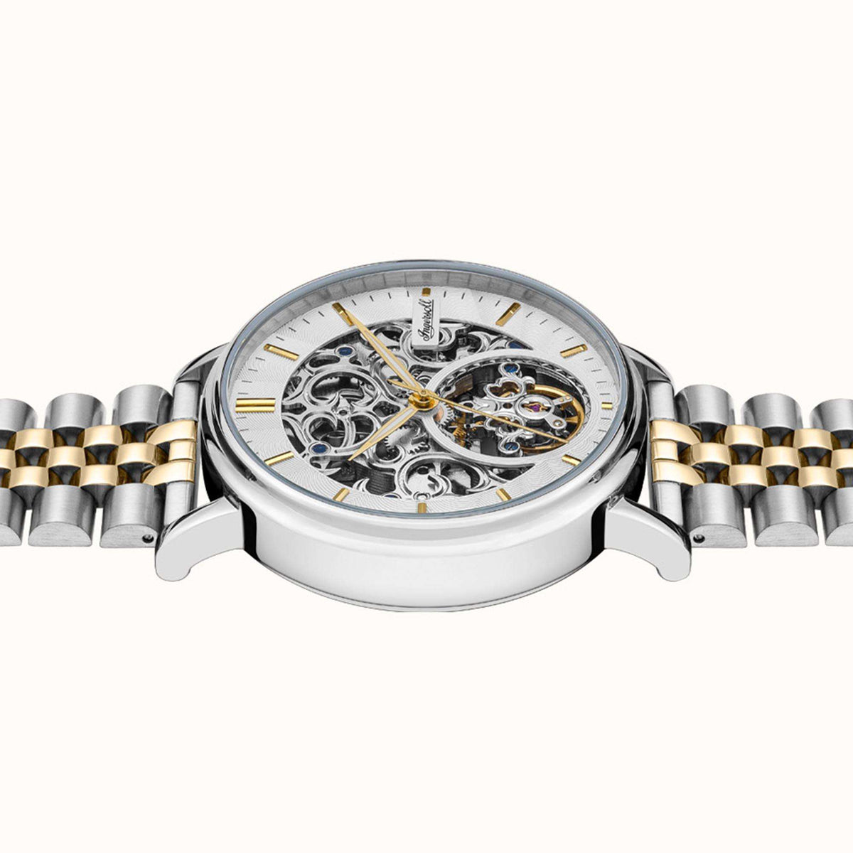 Two-tone stainless steel automatic watch showing silver skeleton dial with gold markers