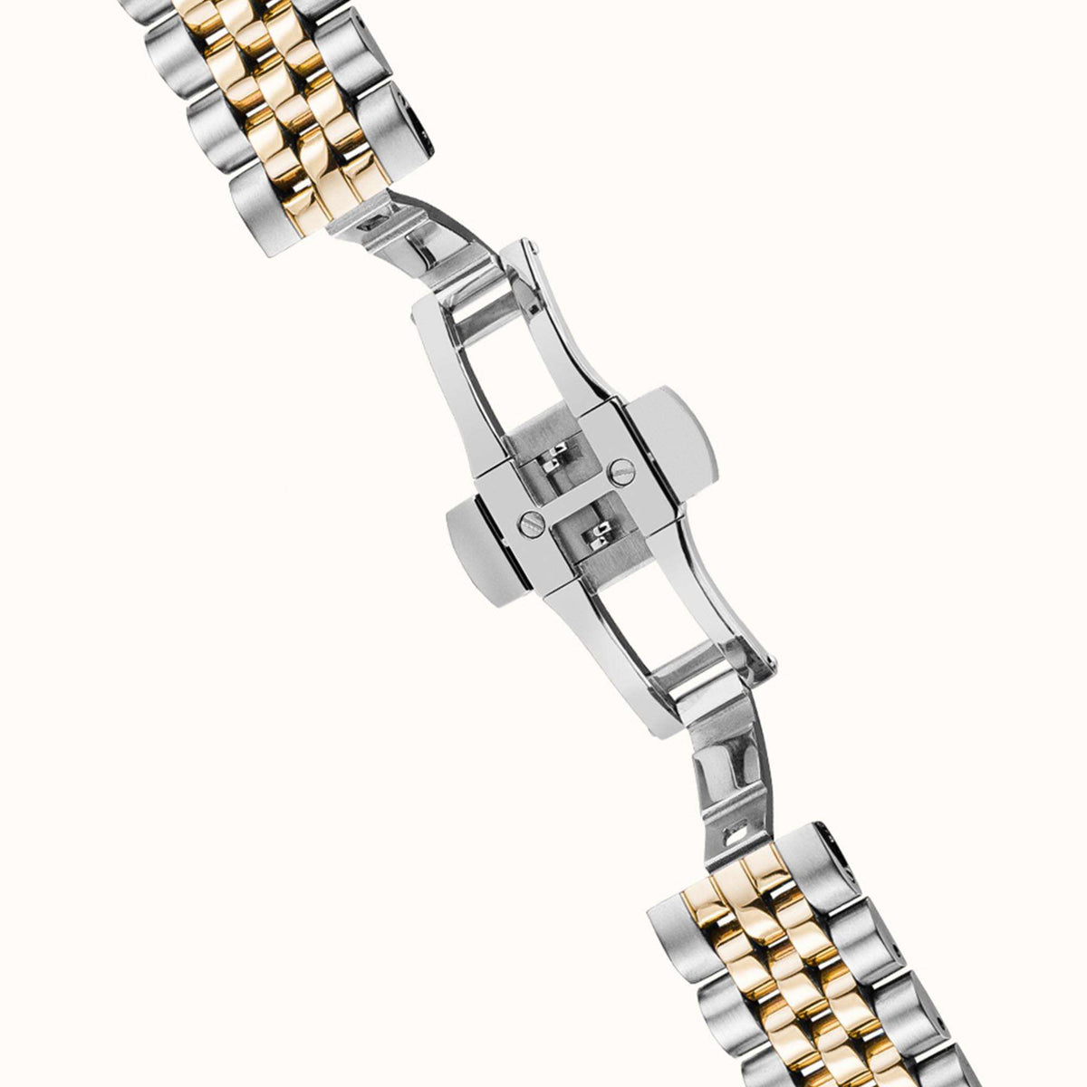 Two-tone metal bracelet with fold-over clasp and linked band details