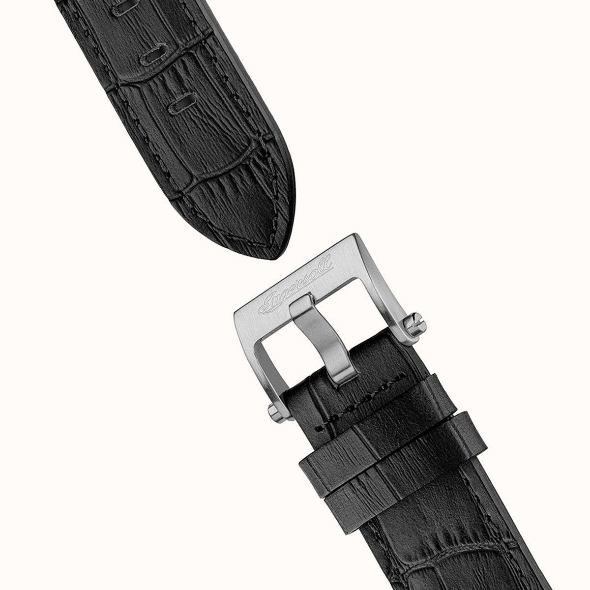Black leather watch strap with metal buckle and keeper on a silver clasp