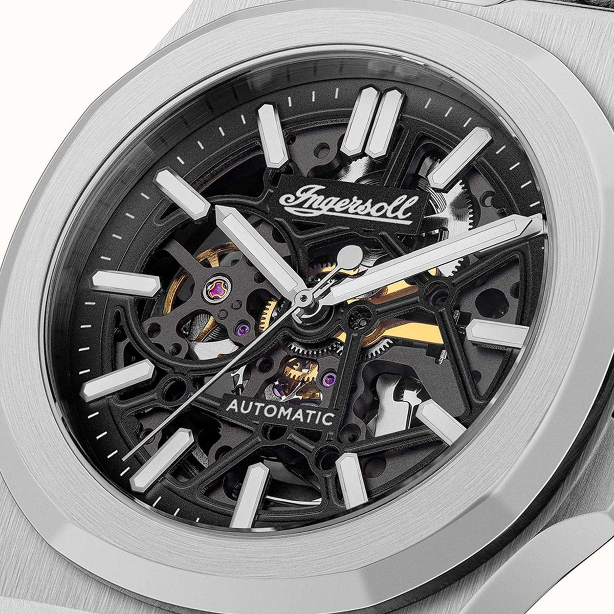 Men's automatic skeleton watch close-up: black dial with silver hands and visible gears