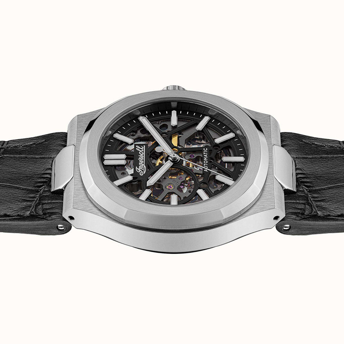 Men's automatic skeleton watch front view with black dial, silver case, and black leather strap