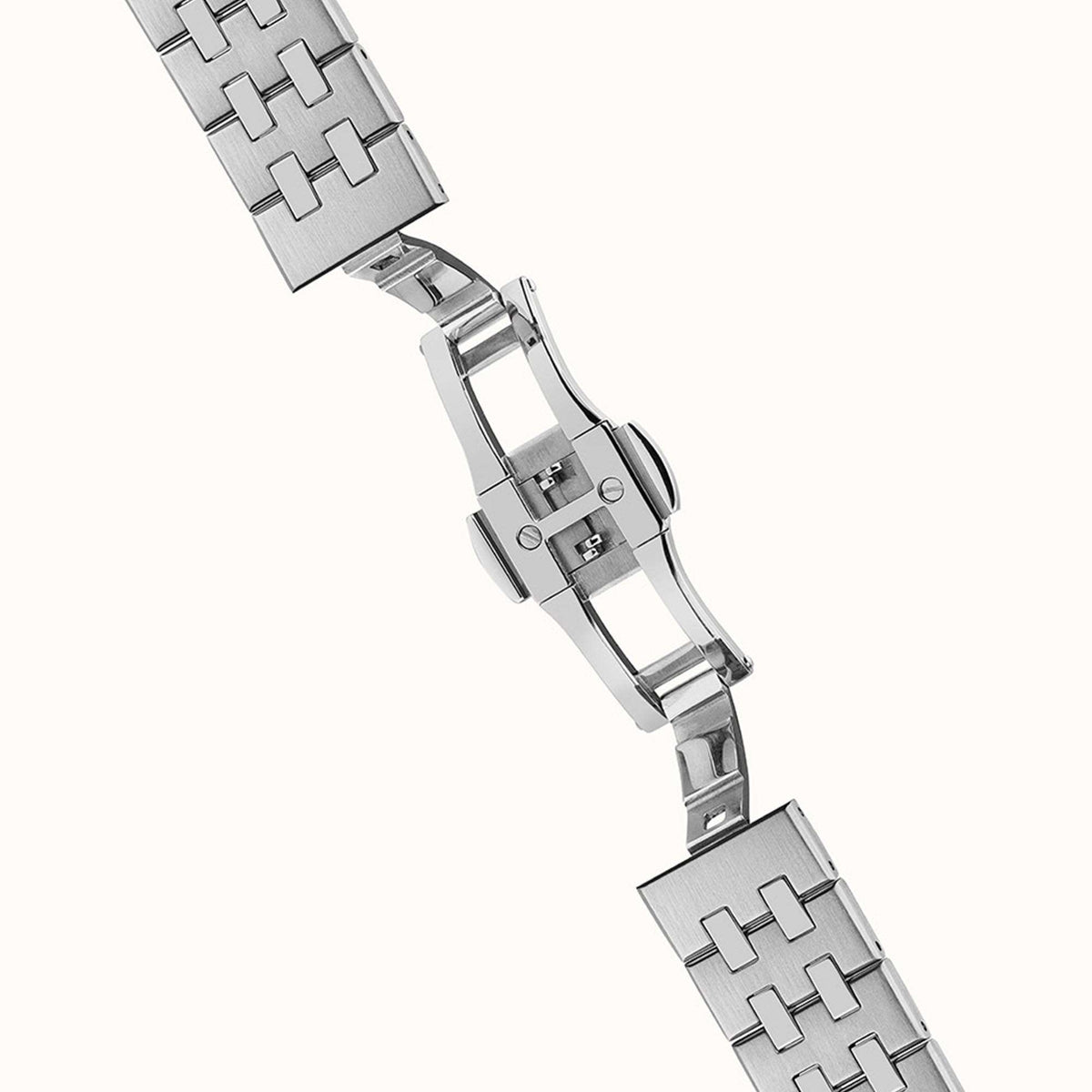 Stainless steel link bracelet with clasp and polished end links on an automatic wristwatch