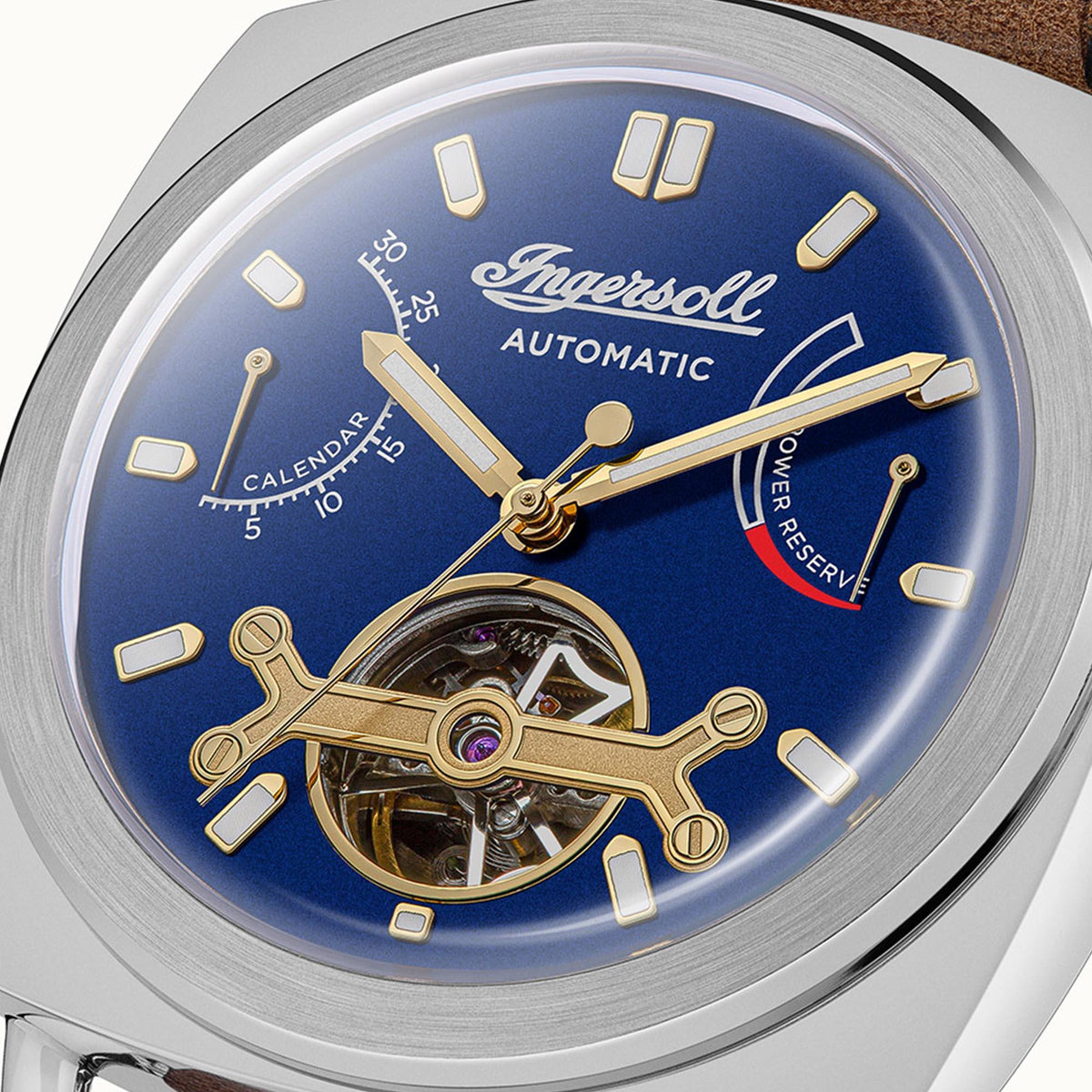 Blue automatic dial with gold markers and hands plus visible inner mechanism, steel case
