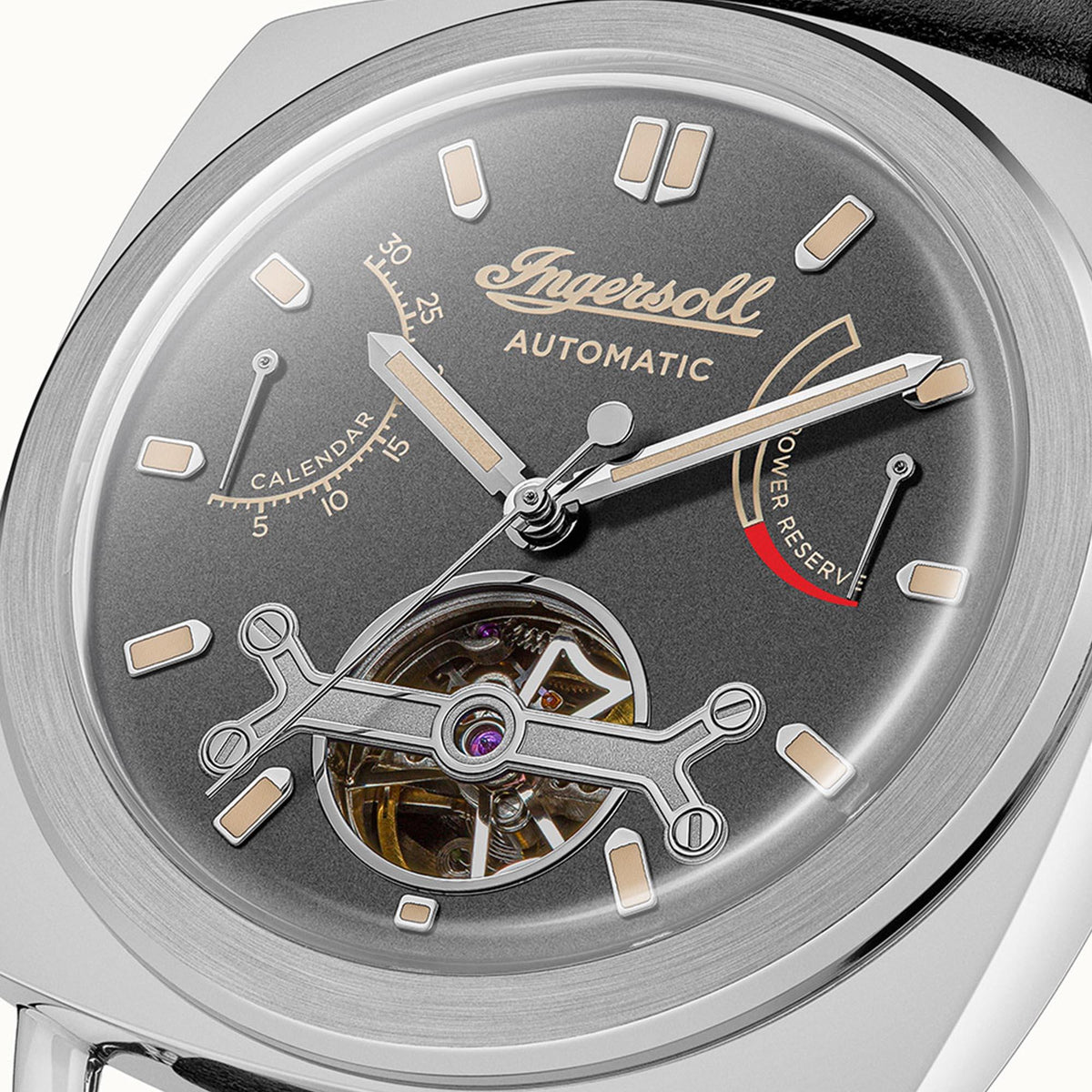 Close-up of grey automatic dial with light markers and visible mechanical details