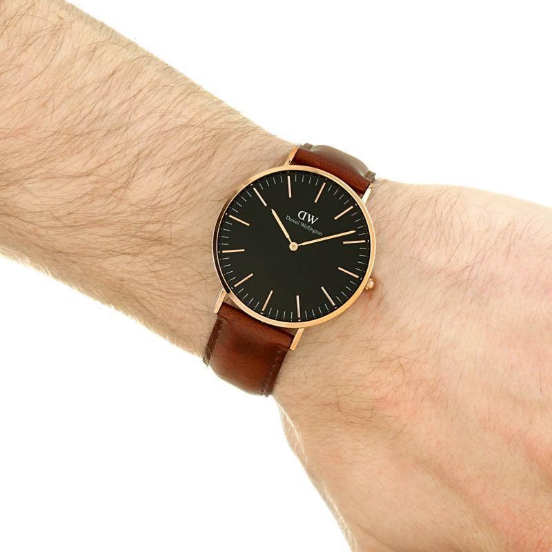 Men's wrist watch with brown leather strap and black dial, gold-tone hands