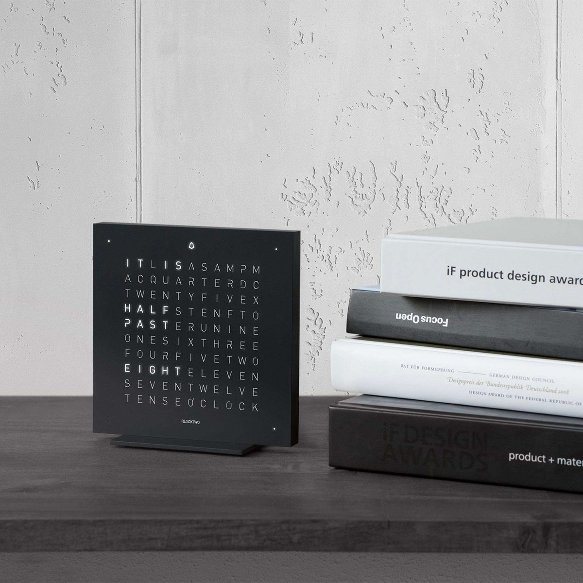 QLOCKTWO deep black touch table clock with word display on tabletop stand