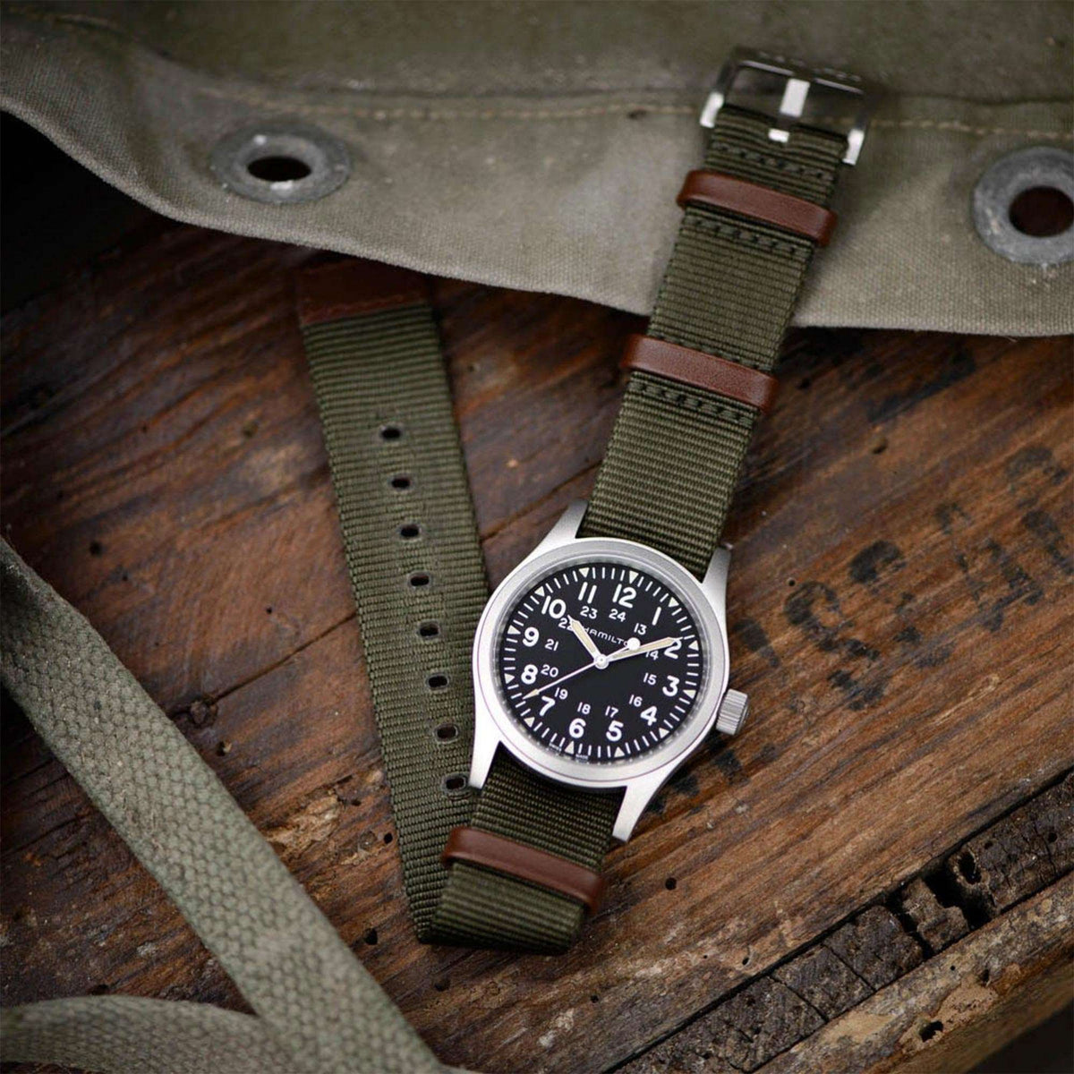 Hamilton Khaki Field H69439931 flat lay on rustic wooden surface