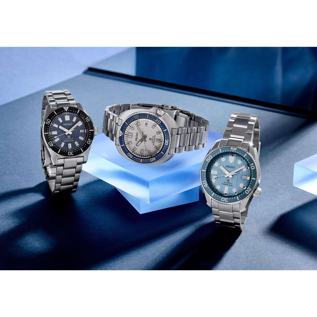 Group product display featuring the Seiko Prospex watch SPB297J1 alongside two other models from the same collection on clear acrylic blocks.