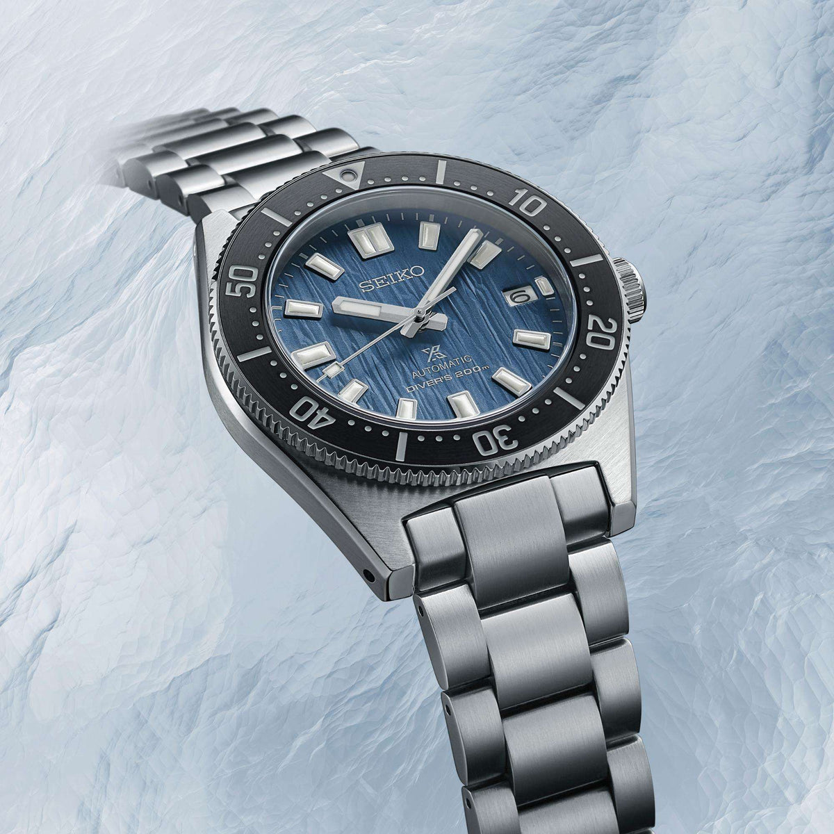 Seiko Prospex watch SPB297J1 showing the stainless steel bracelet and side case profile against an icy background.