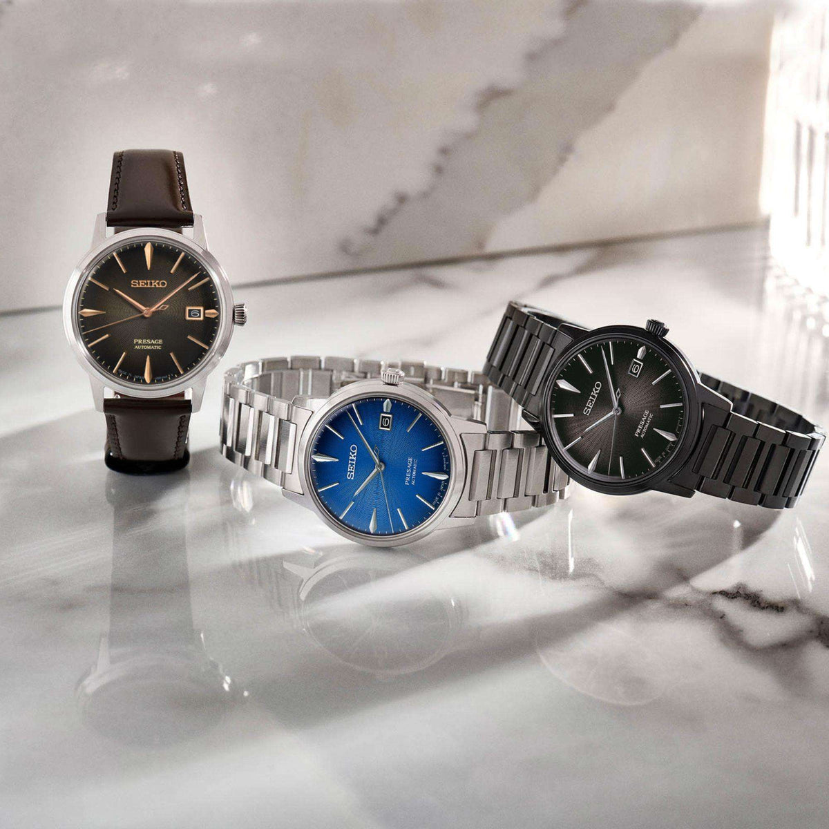 Black dial automatic wristwatch with black PVD bracelet on marble surface