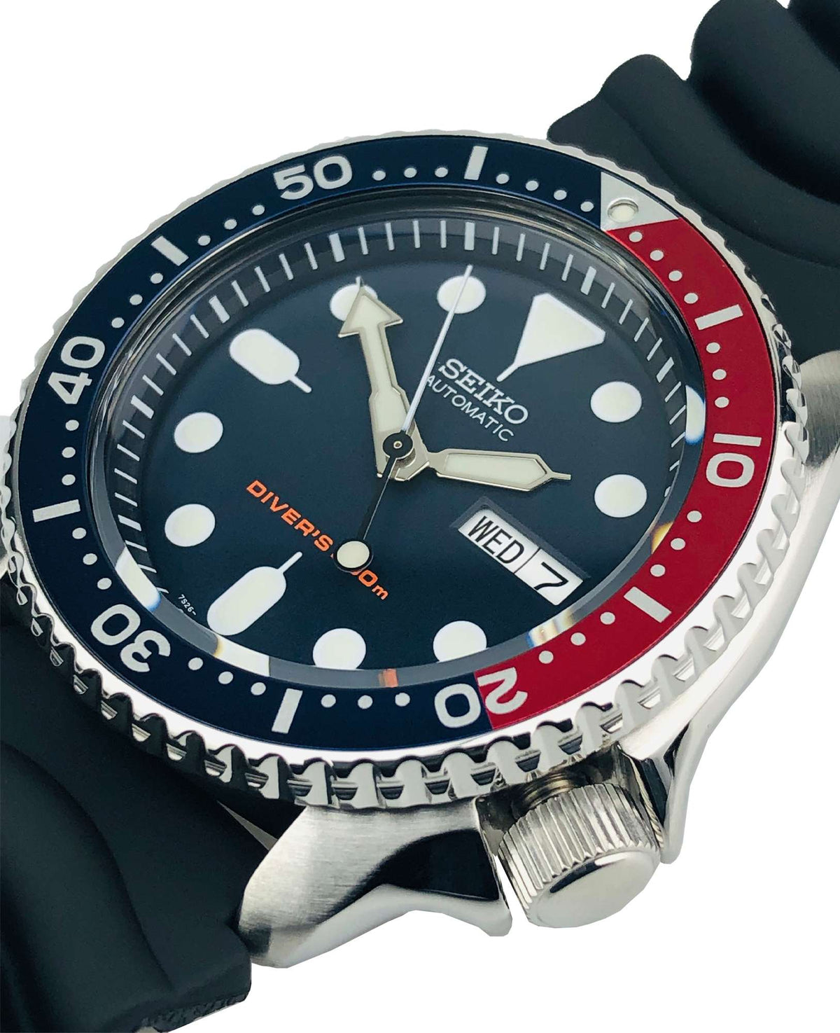 Seiko diver watch close-up top view, dark dial with lume dots and WED date