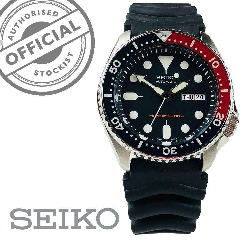 Men's automatic dive watch with black dial, Pepsi bezel, and black rubber strap