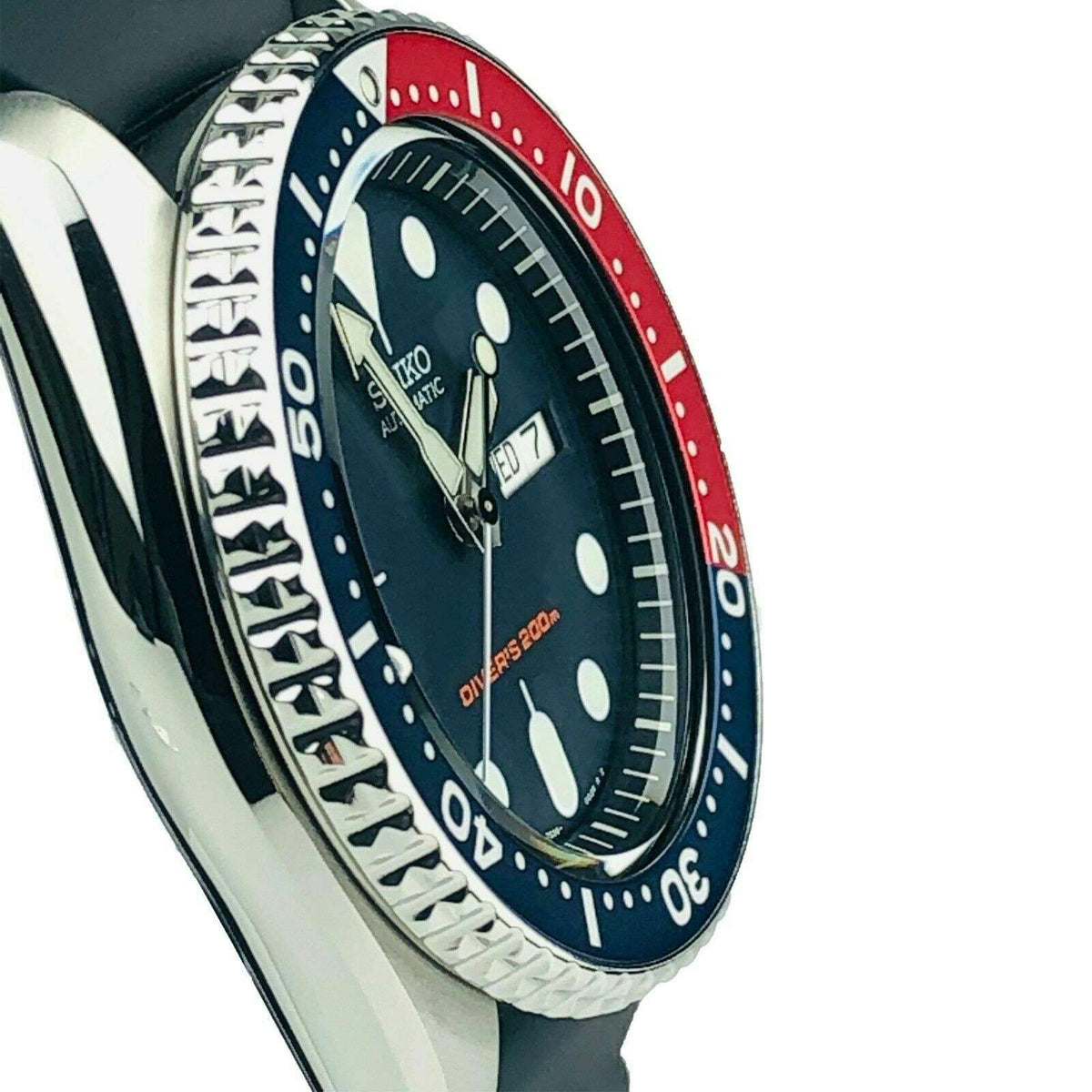 Seiko diver watch close-up with blue-red Pepsi bezel and black dial on metal case