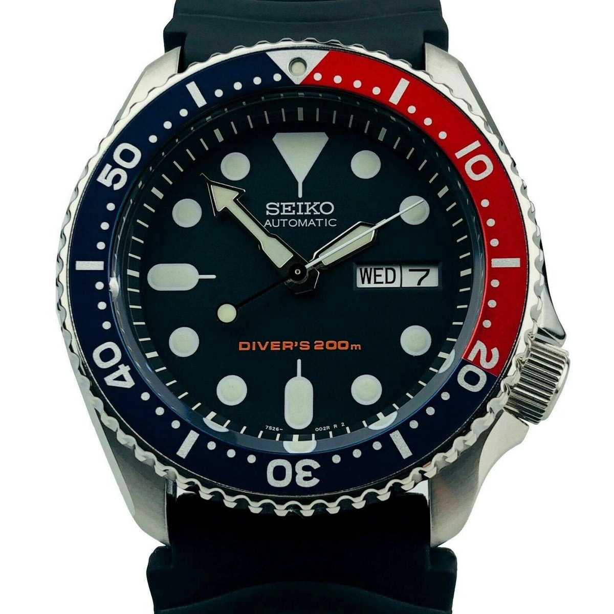 Seiko automatic diver watch with black dial, Pepsi bezel, and black rubber strap