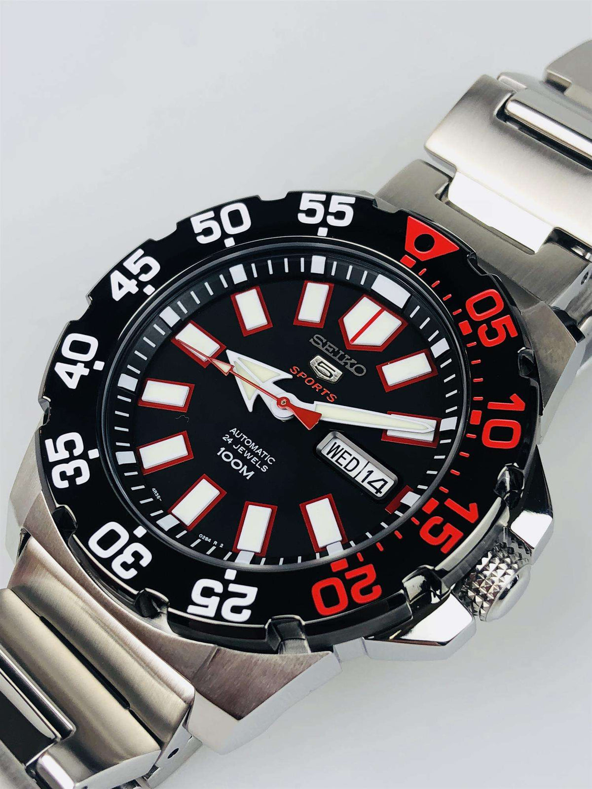 Men's Seiko Sports automatic watch angled view, black dial with WED14 date window