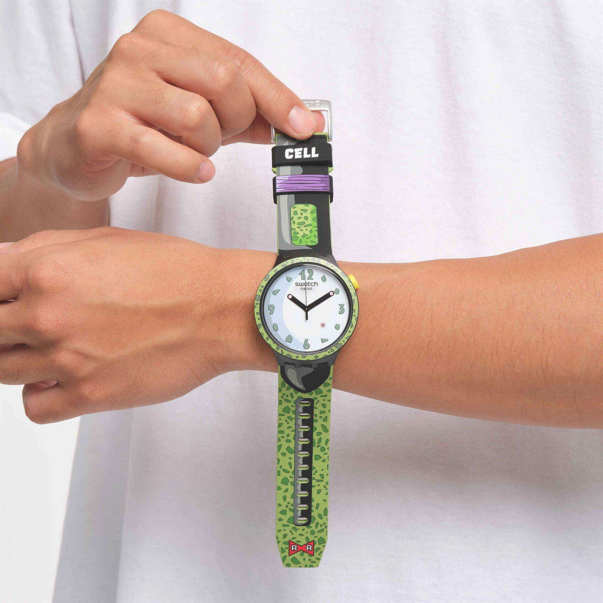 Quartz wristwatch worn on wrist: white dial, black bezel, lime green patterned silicone strap