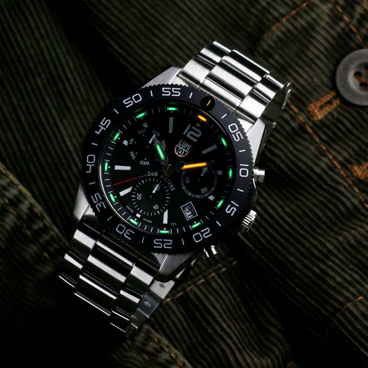Stainless steel diver chronograph watch angled view with black dial and green luminous hands