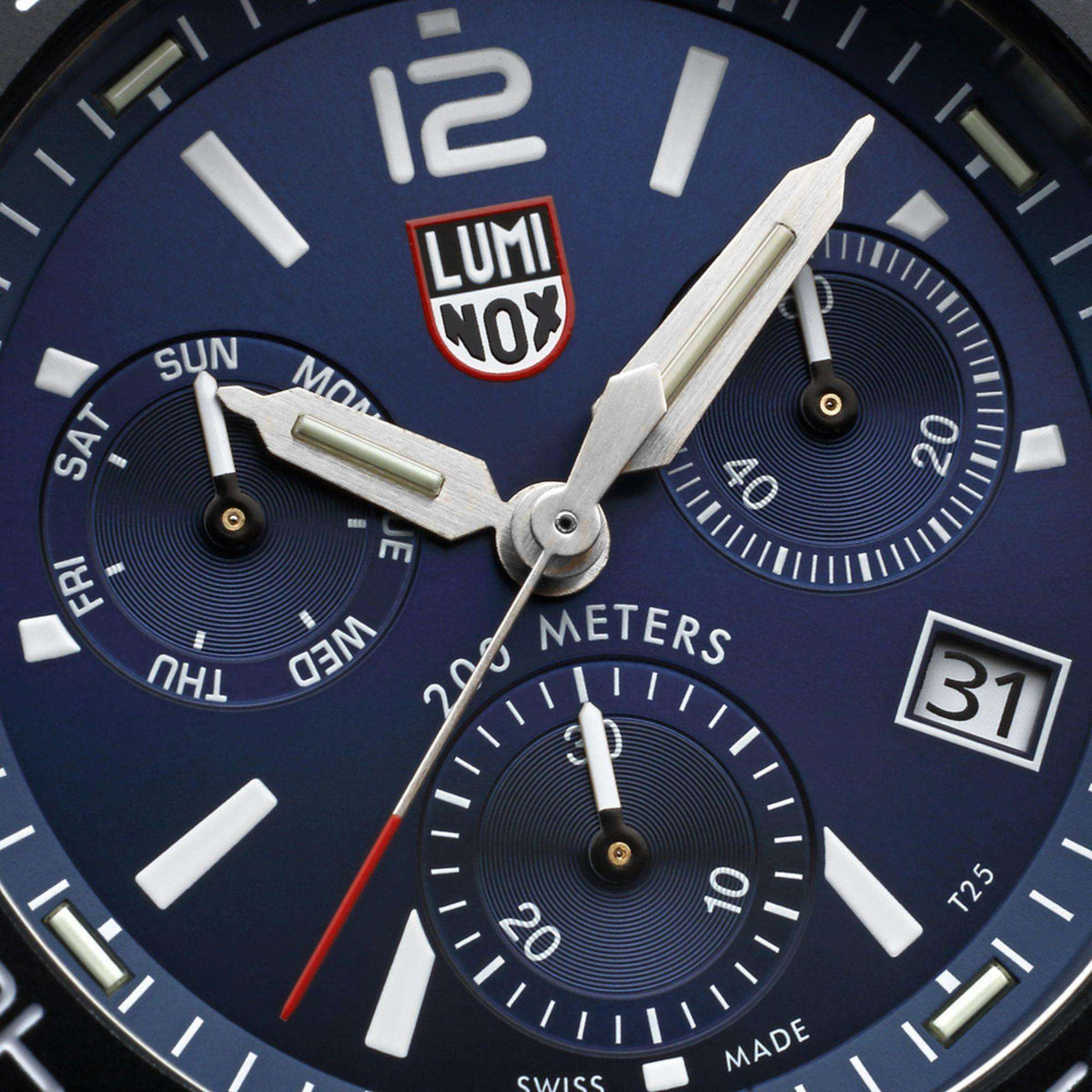 Blue chronograph dial close-up with luminous hands and date window